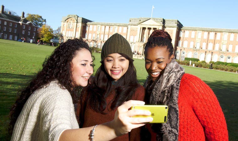Students taking selfie in front of Leeds Beckett University