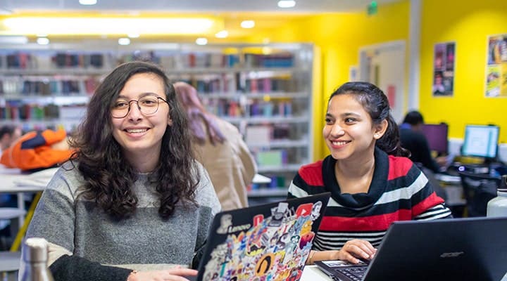 Students smiling in library
