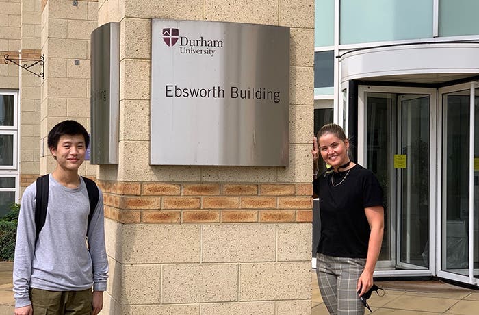 Students smiling in front of Ebsworth Building