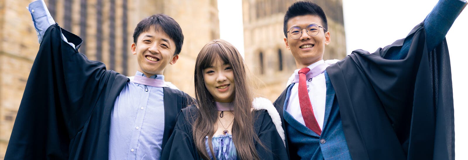 Durham graduates smiling at camera
