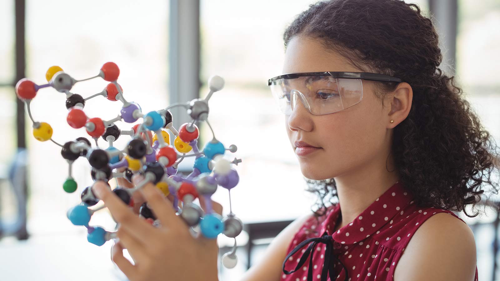 A student with a model of a molecule 
