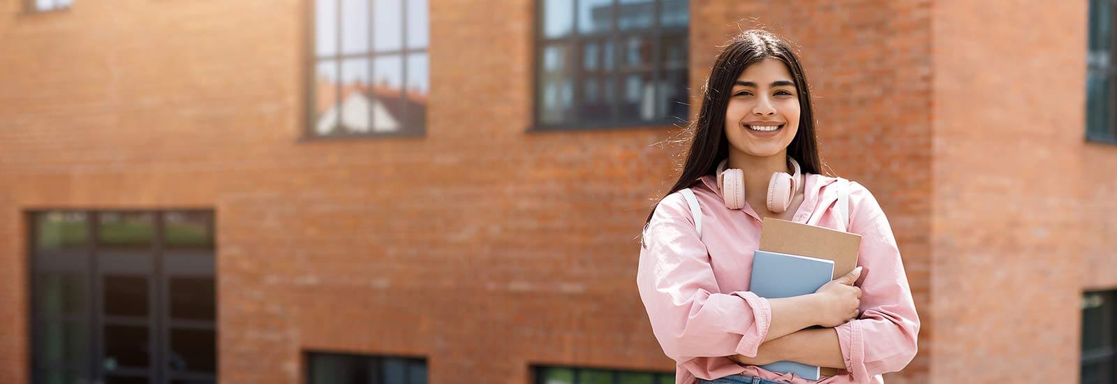 Student smiling outside campus