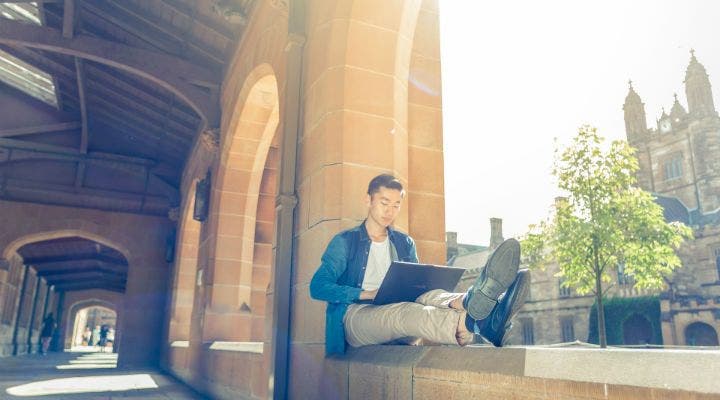 Student on laptop on Taylors Sydney campus grounds
