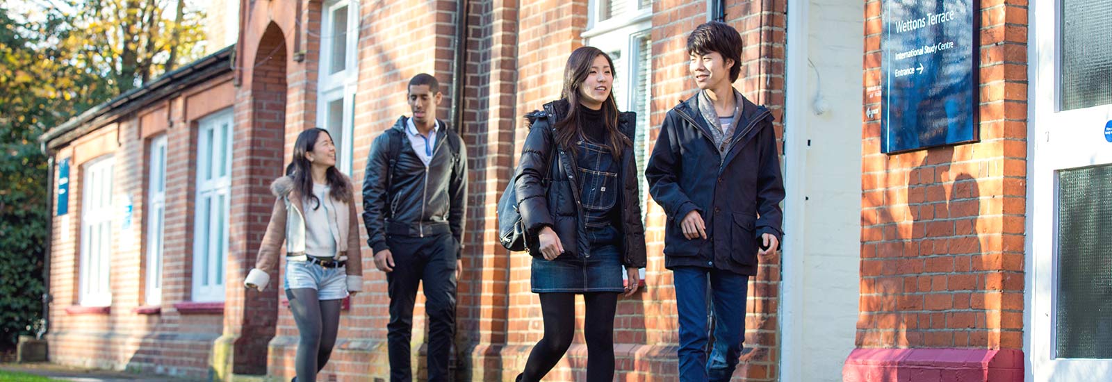 A group of students walking past a campus building