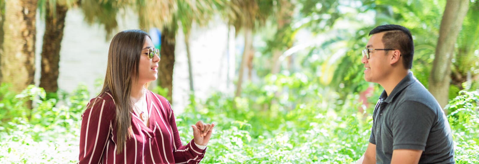 Students talking outside by trees
