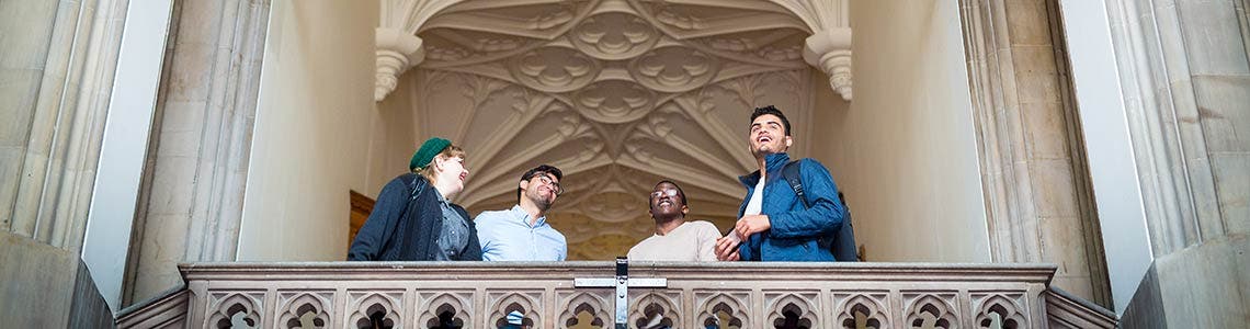 Students gathered on a balcony on campus