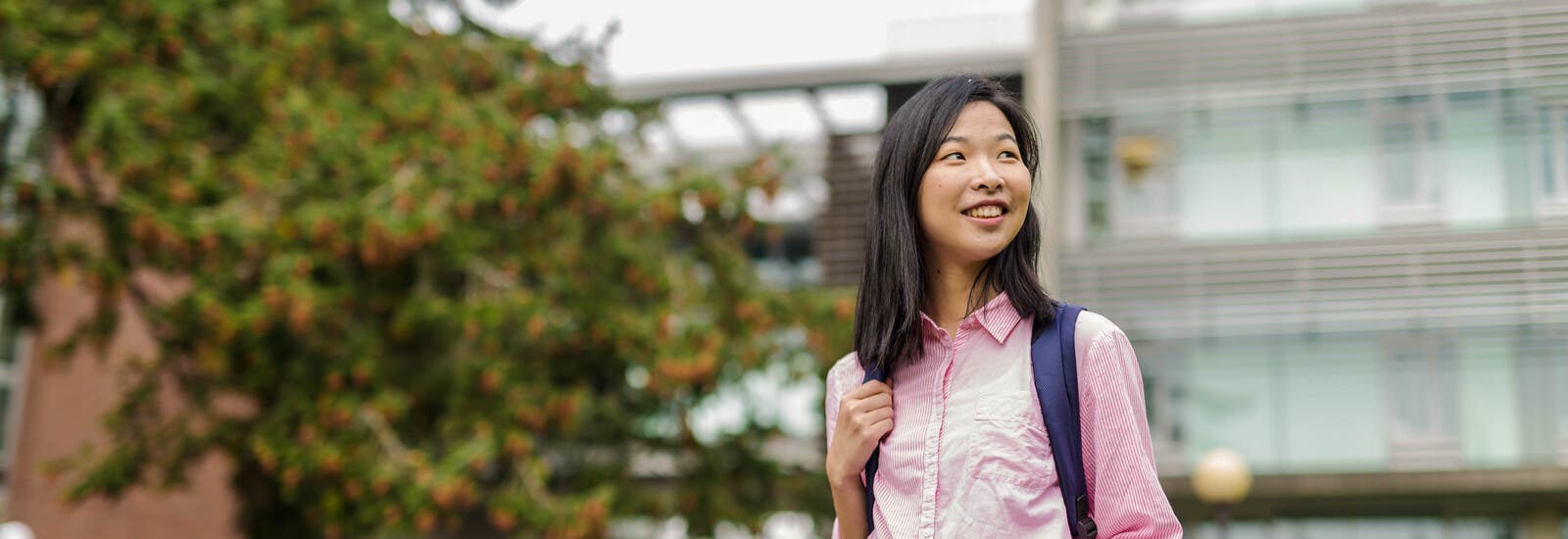 Student smiling outside campus