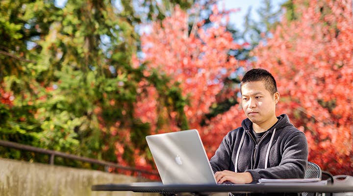 Student on laptop outside
