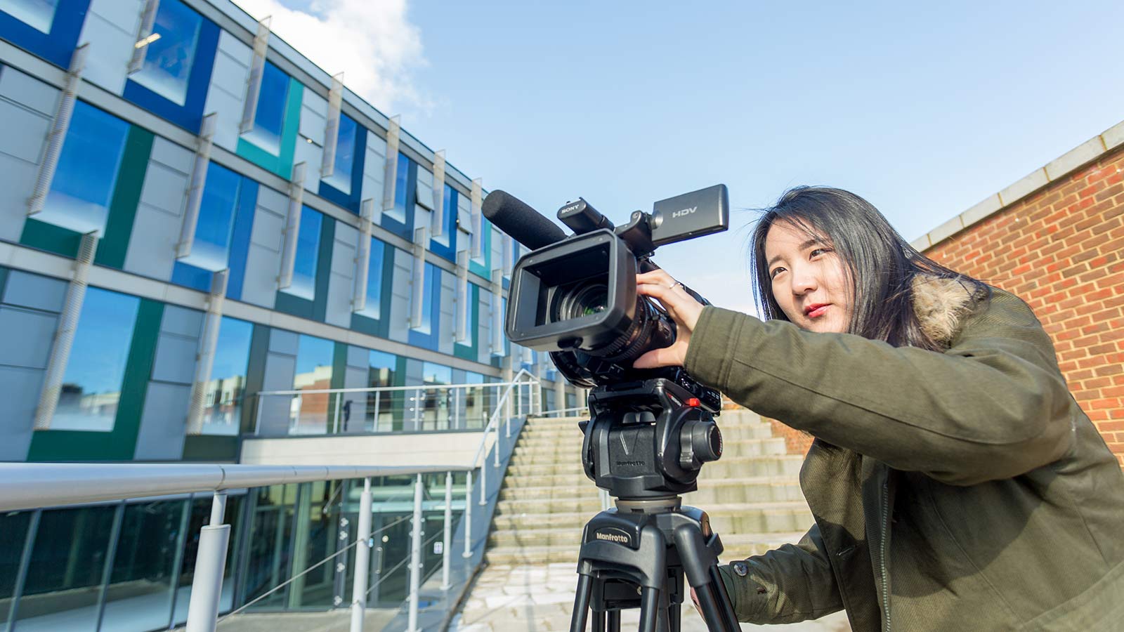 A University of Sussex student filming on campus