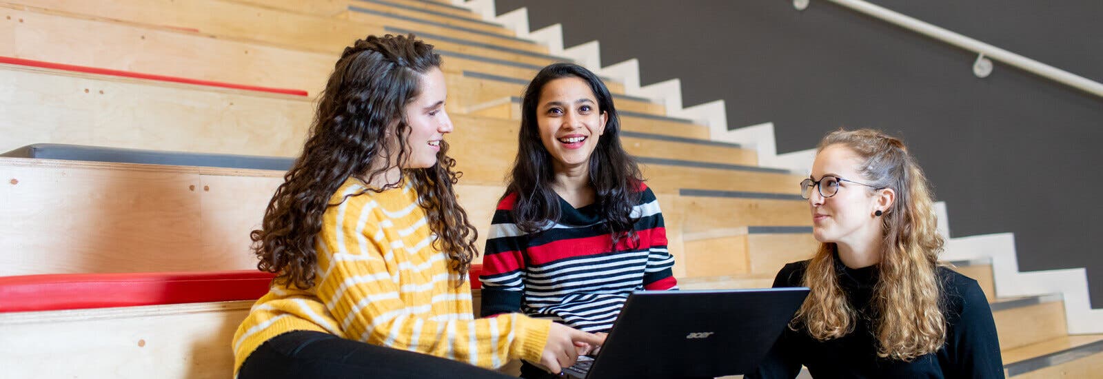 Students studying on lecture hall bench