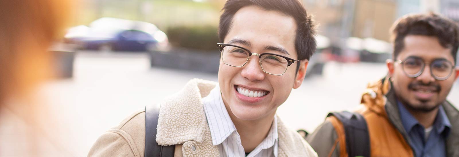 A student facing the camera and smiling