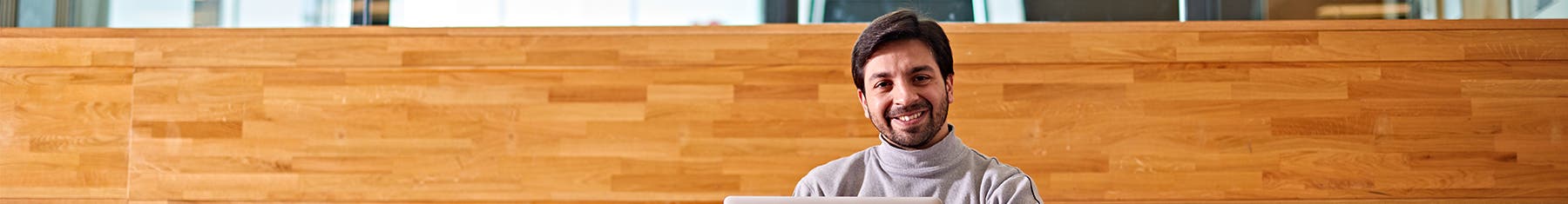 Student smiling at camera on campus