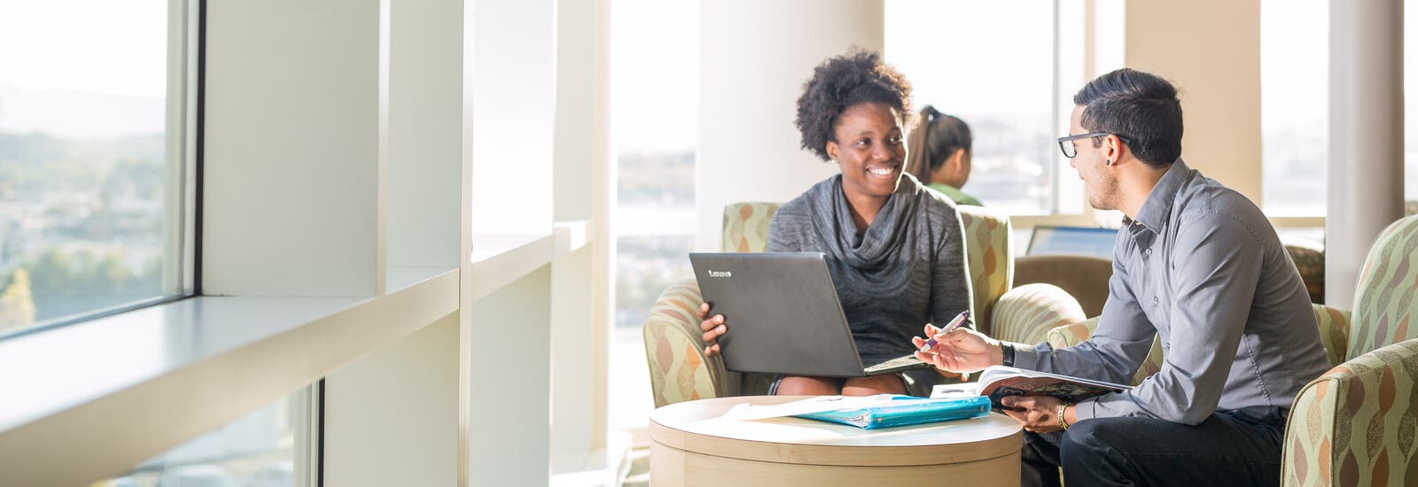 Two students studying together at a table