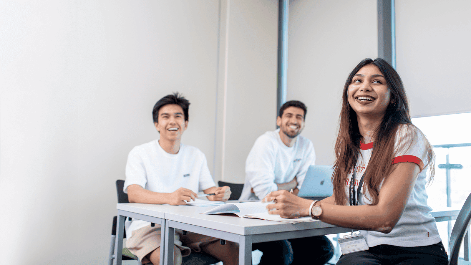 A graduate in a crowd smiling at the camera