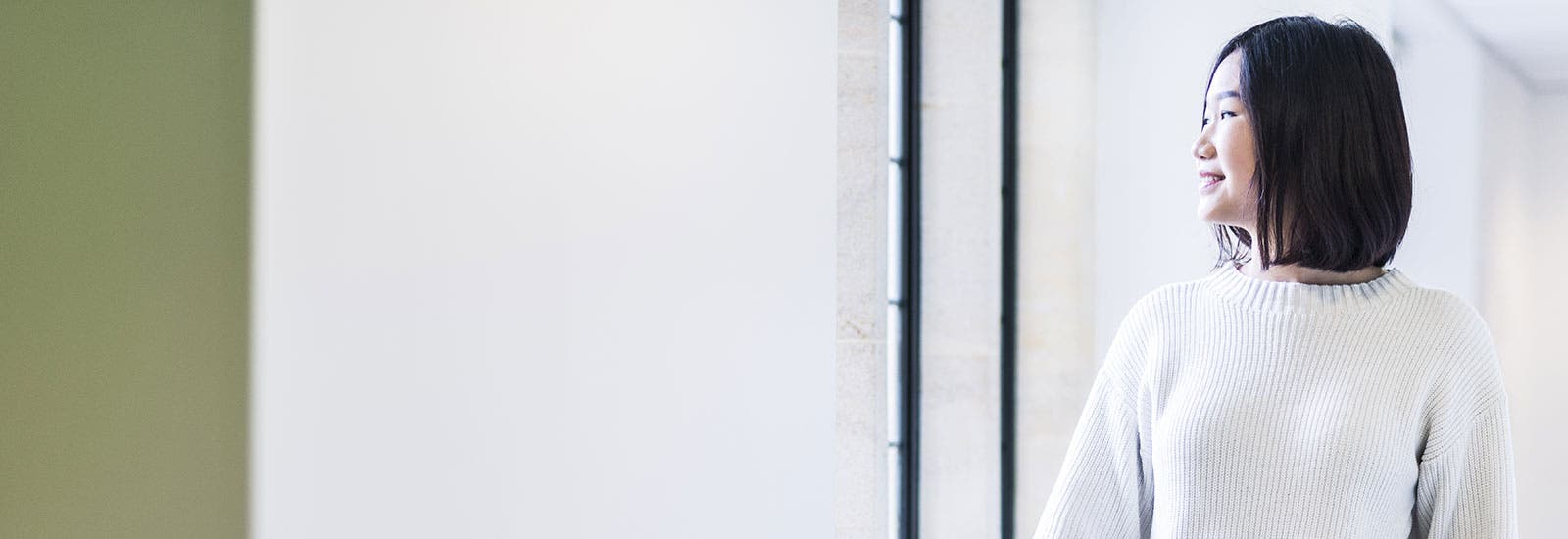 Student looking out of window and smiling