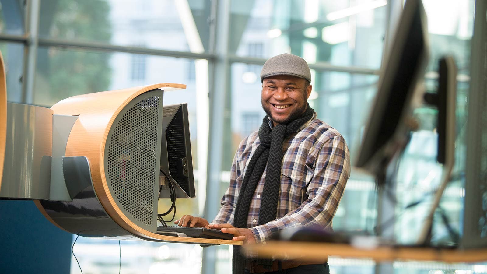Student smiling and using computer