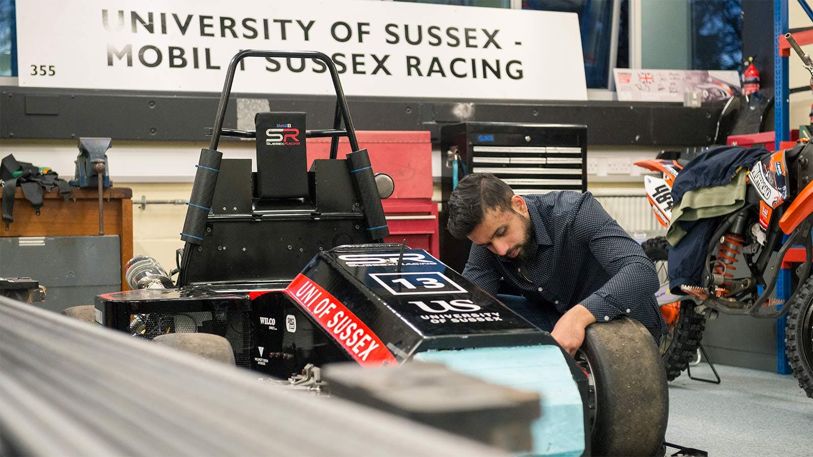 A University of Sussex student working on a race car