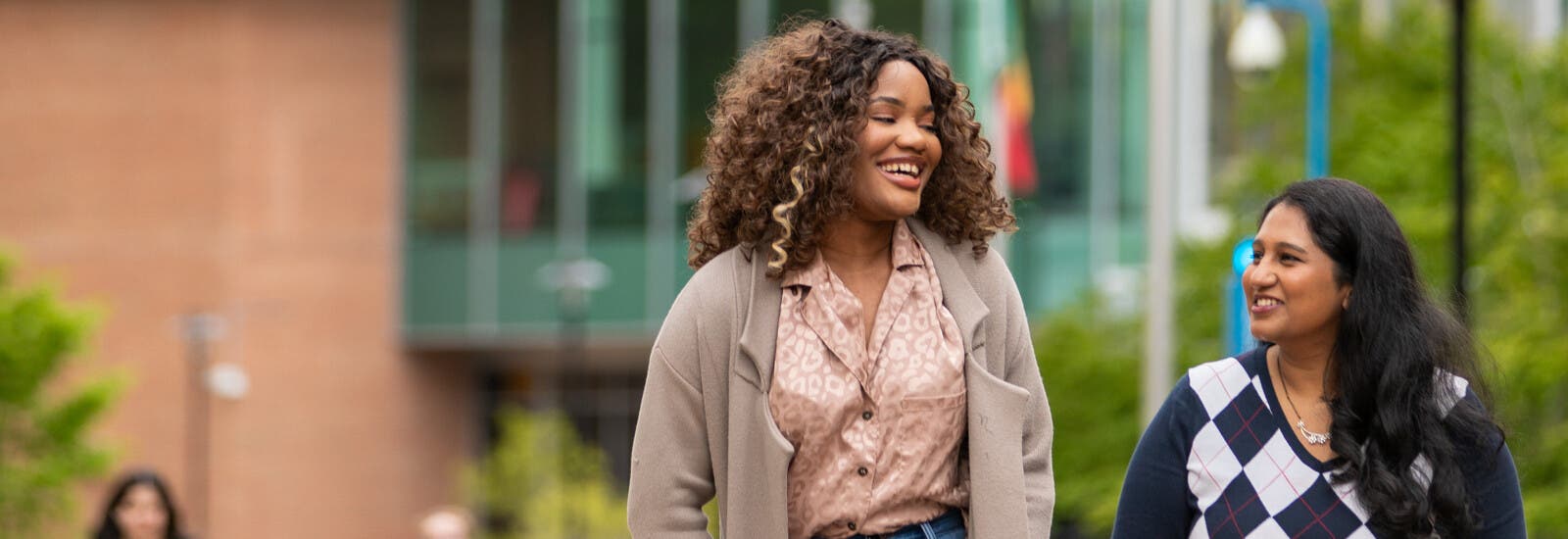 Two students walking together outside campus