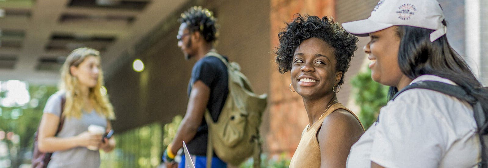 Two students sitting outside campus
