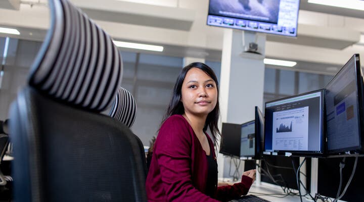 Student posing by computer