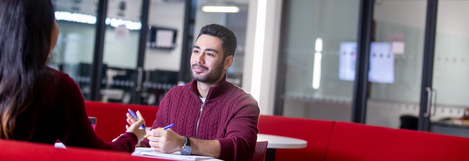 Students talking at a table on campus