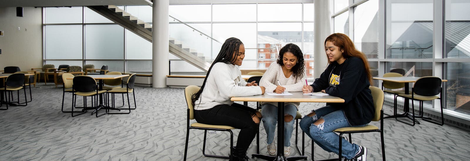 Three students studying at a table