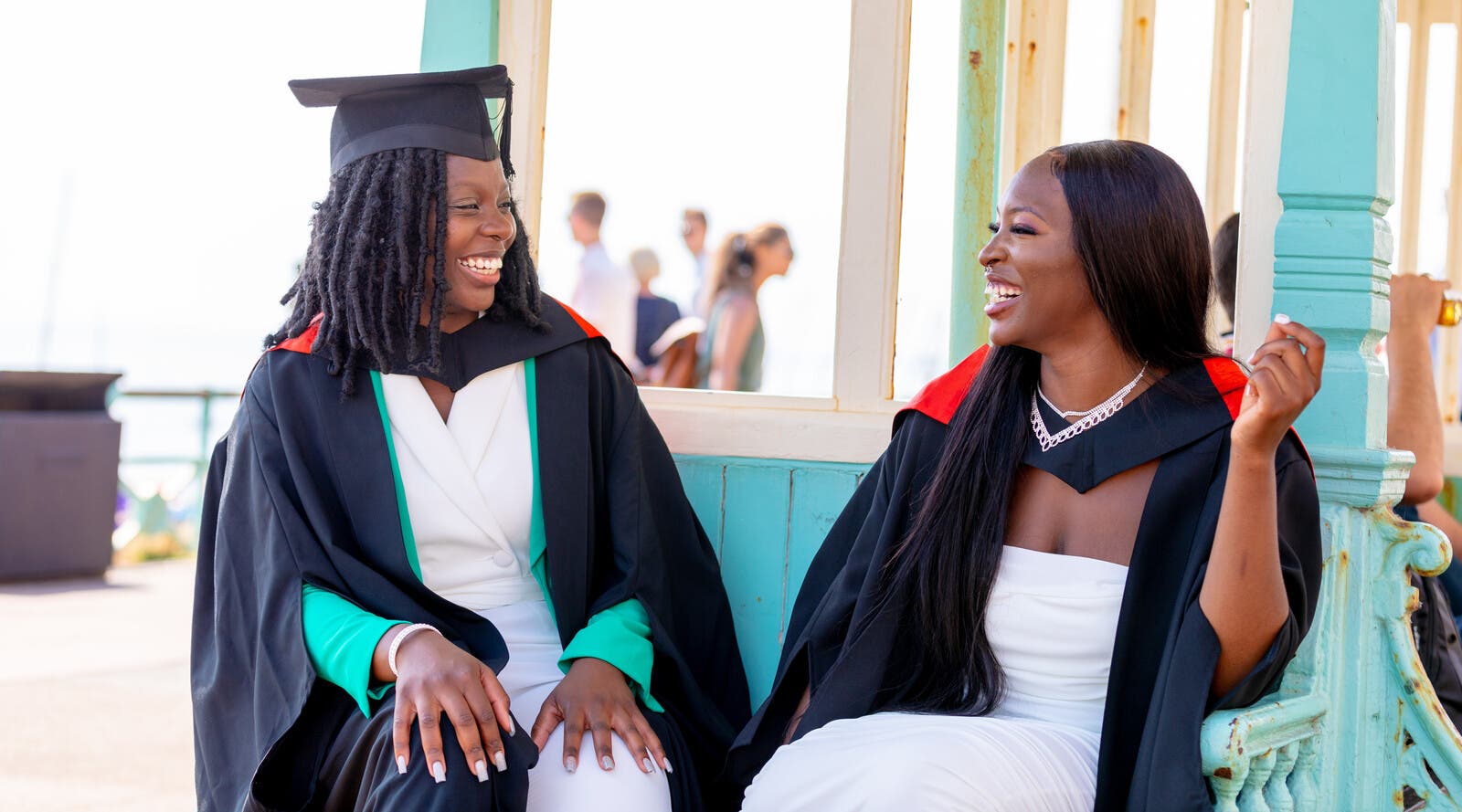 Two students in their graduation robes.