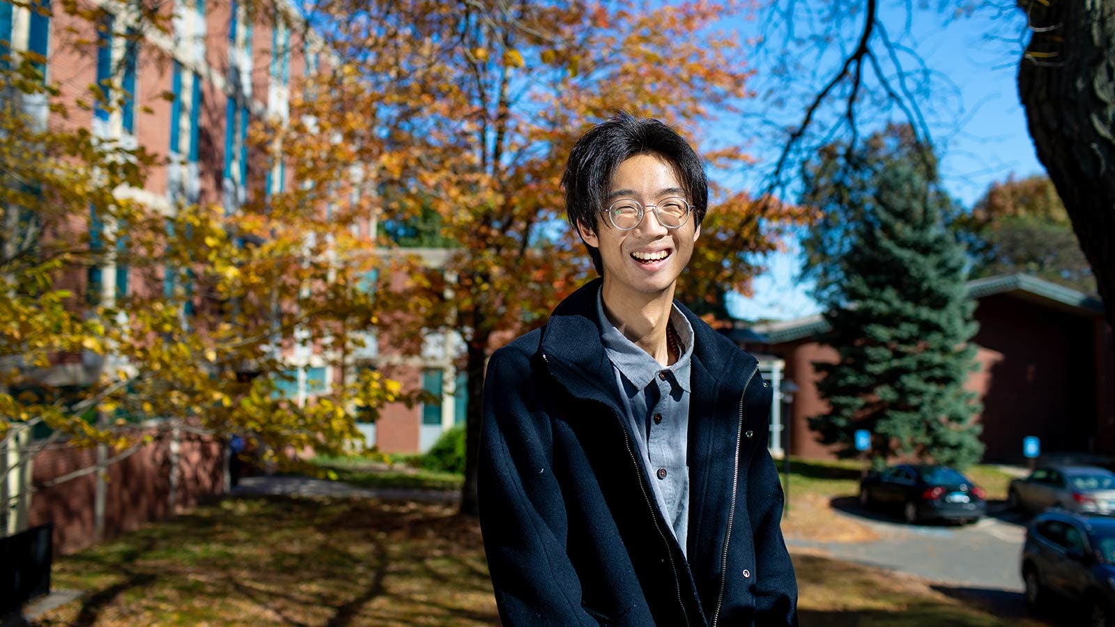 Student smiling outside campus