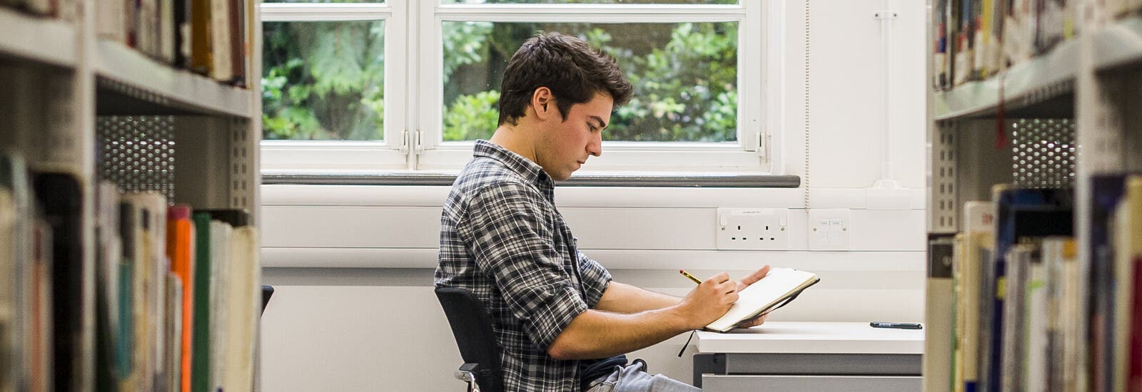 Kingston University international student in the library