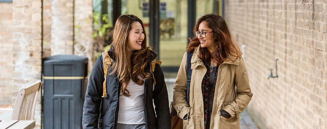 Two students walking on campus