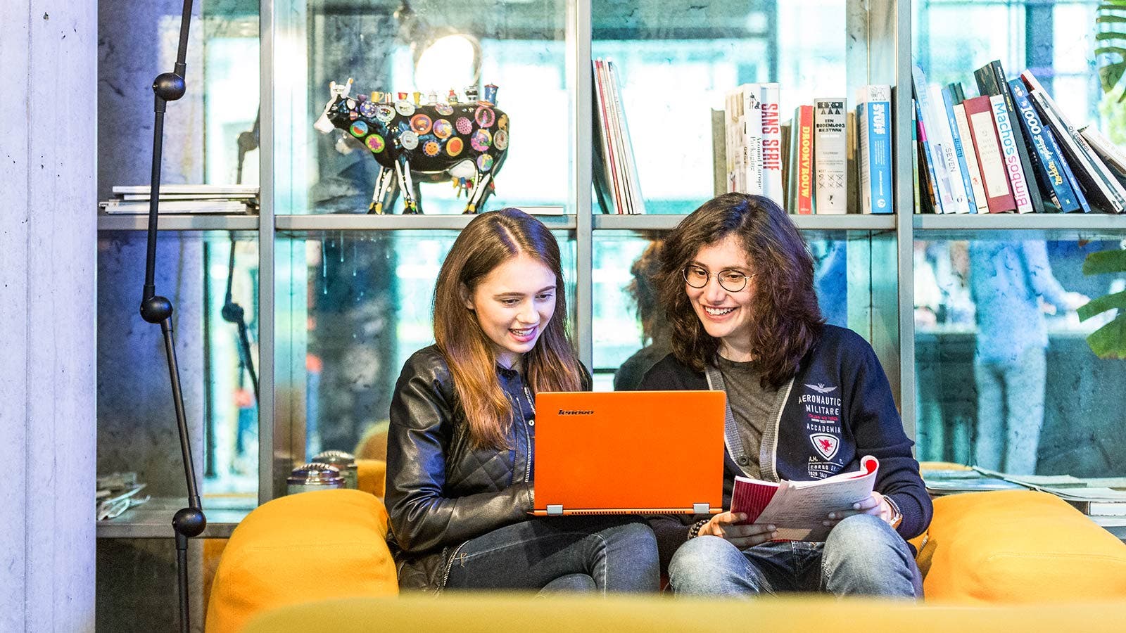 Two students sitting in library and studying together