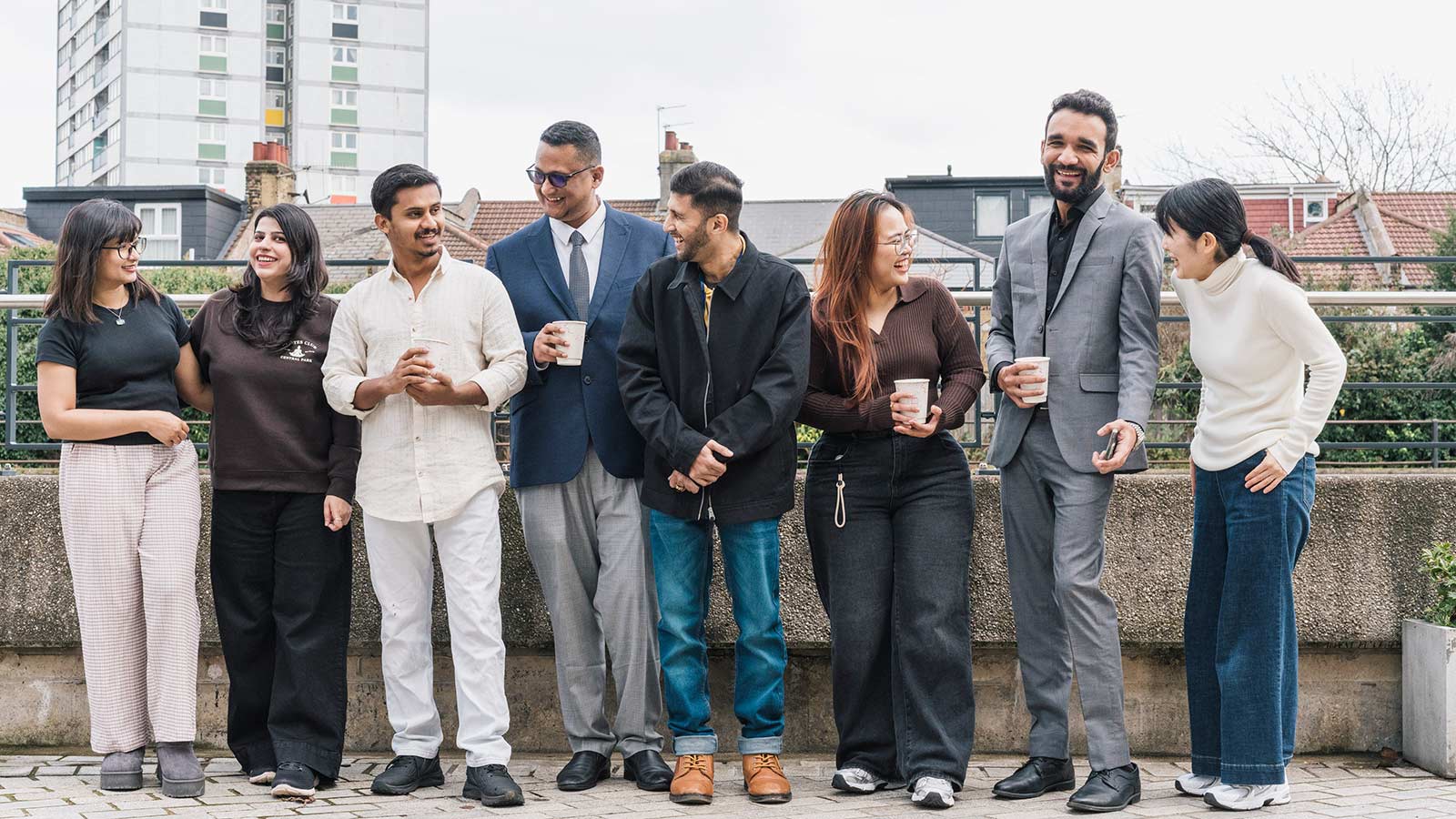 Students stood outside smiling and laughing