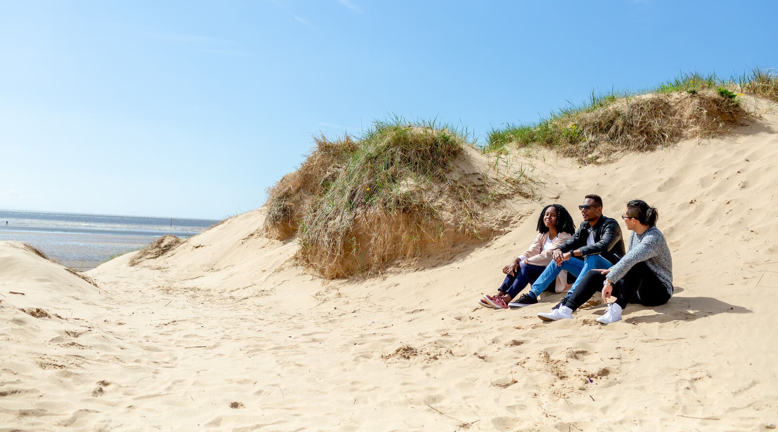 Students sat on a beach