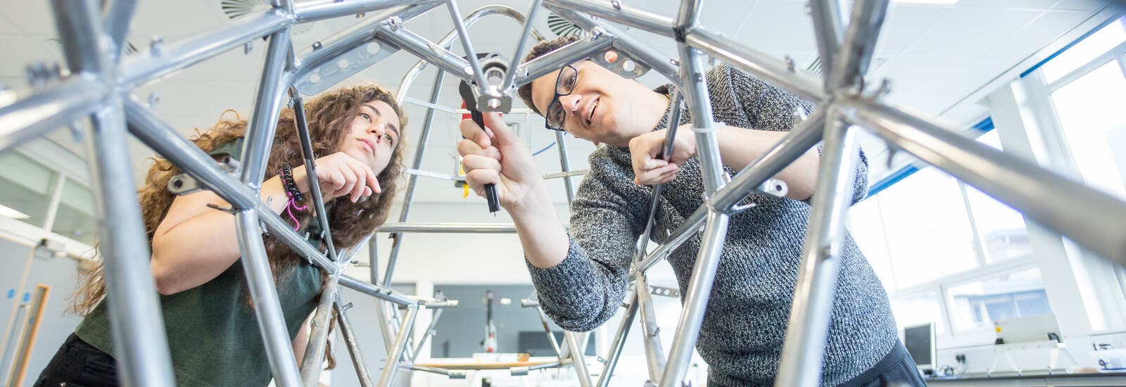 Two engineering students working on a project.