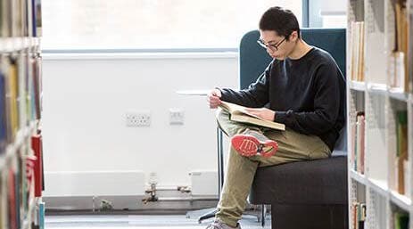 A Lancaster ISC student reading in the library