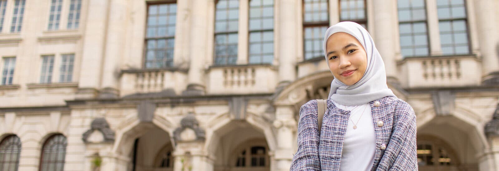 Student smiling outside campus