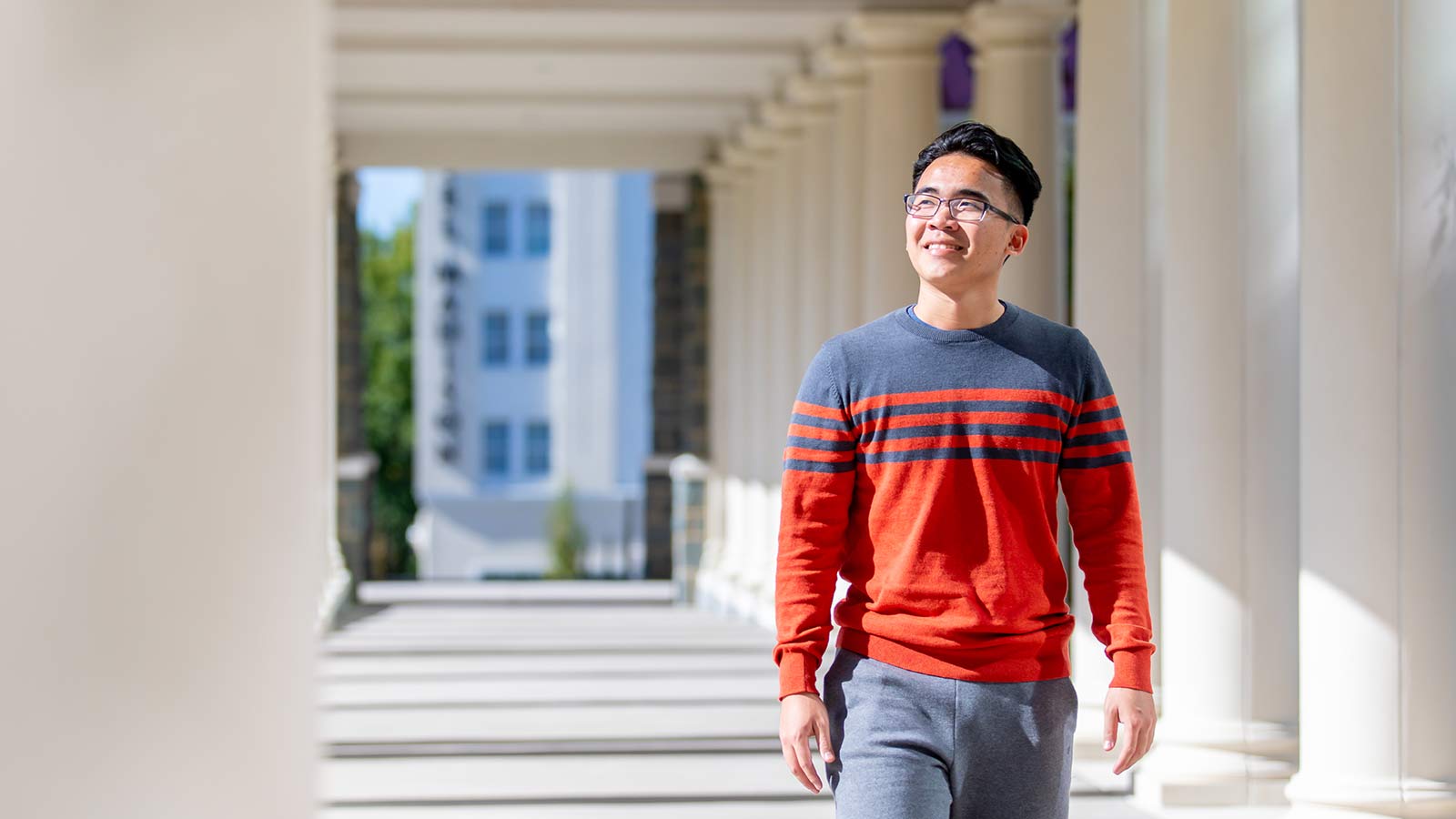A James Madison University student walking through campus