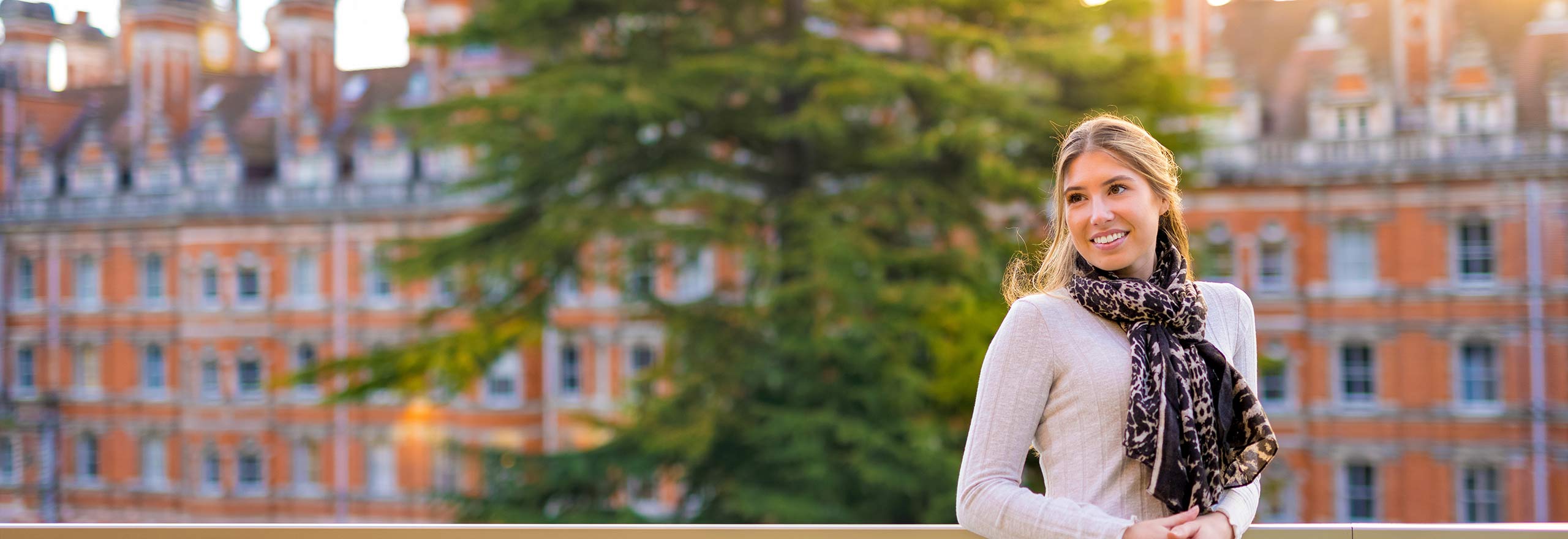 Student smiling in front of row of houses