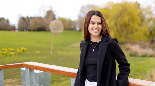 Student smiling outside campus