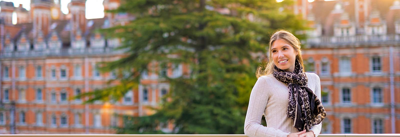 Student smiling in front of row of houses