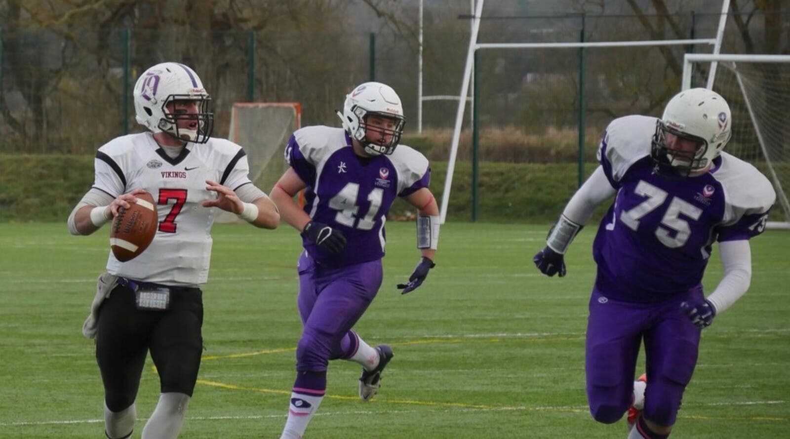 Students playing American football.