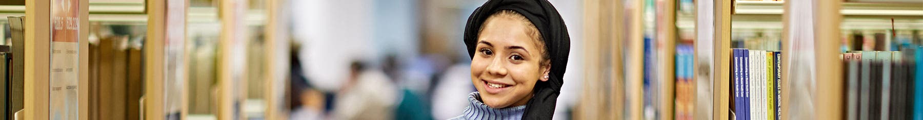 Student smiling in library
