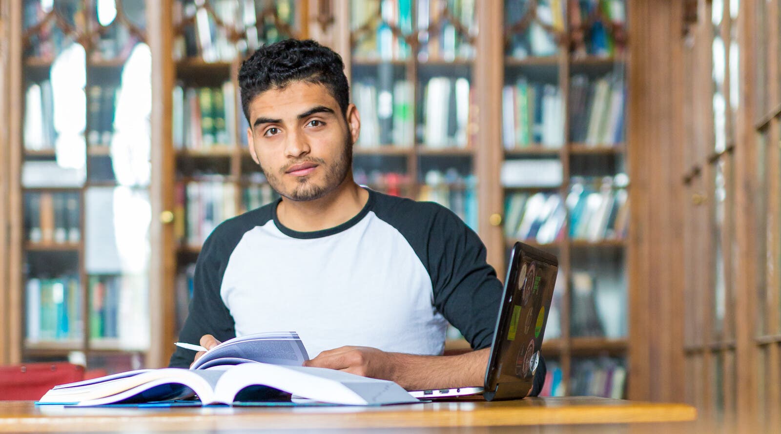 Israr, from Pakistan, in a library.