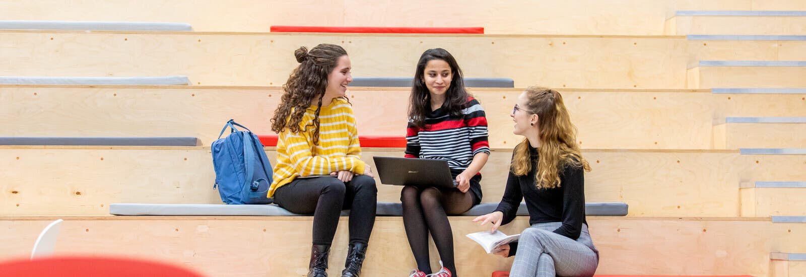 Students sitting on lecture hall benches
