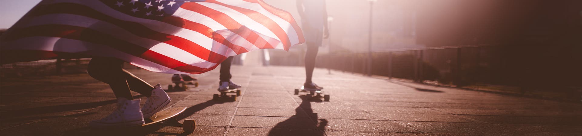 Students skateboarding with American flag