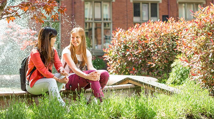 Students sitting outside campus