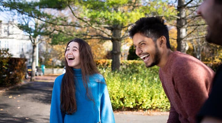 Students laughing outside campus