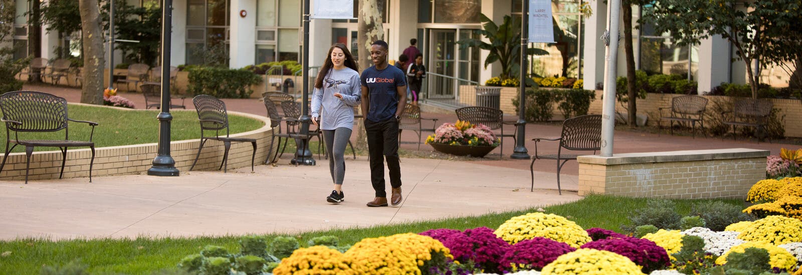 Two students walking outside campus