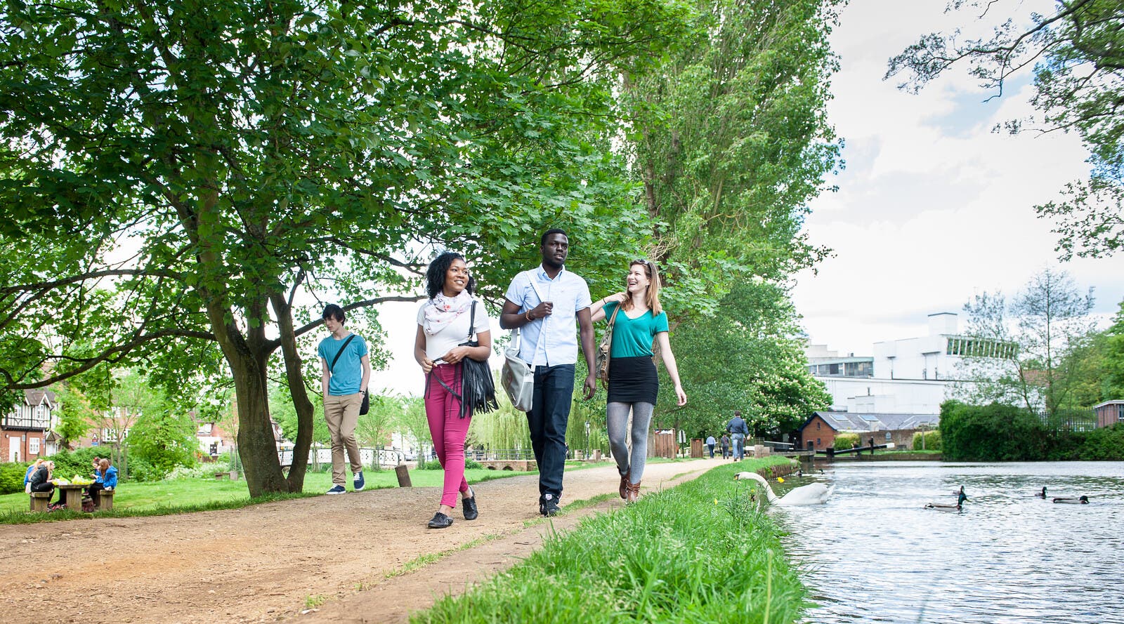 Students walking by canal in Surrey