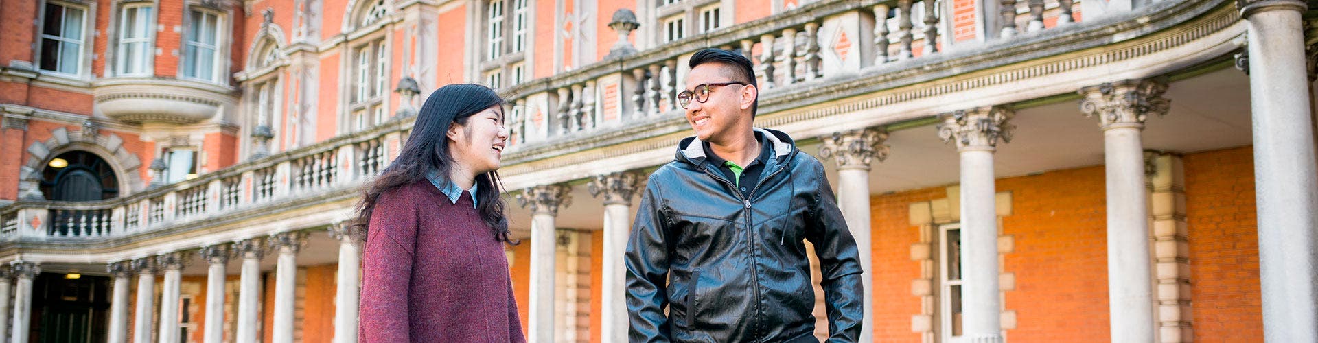 Two students walking on Royal Holloway's campus